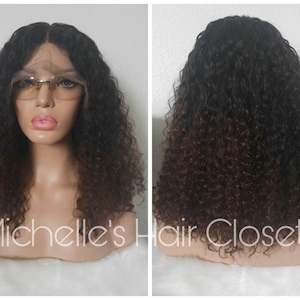 May include: A curly human hair wig with a dark brown to black ombre color. The wig is on a mannequin head with a lace front.