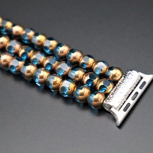 May include: A beaded watch band with blue and gold beads and a silver watch band connector.