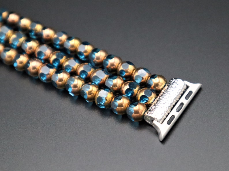 May include: A beaded watch band with blue and gold beads and a silver watch band connector.