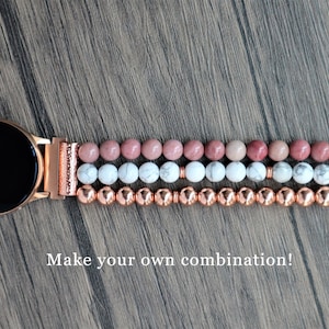 May include: A rose gold smartwatch band with three rows of beads. The top row is pink, the middle row is white, and the bottom row is copper. "Make your own combination!" is written below the band.