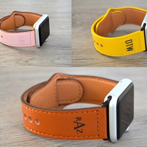 May include: Three Apple Watch bands in different colors: pink, yellow, and brown. Each band is made of leather and has a personalized inscription. The inscriptions are "ALS", "DTW", and "RAZ".