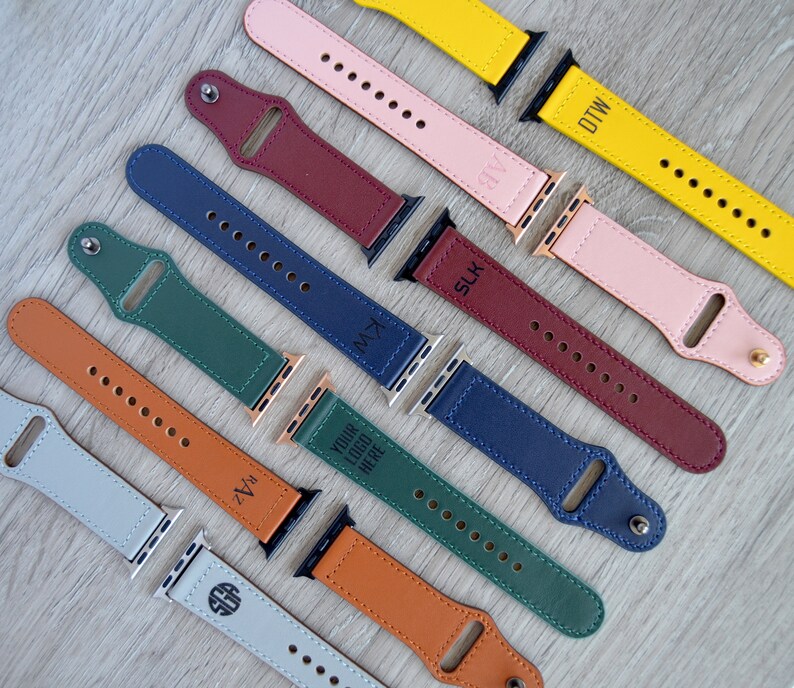 May include: Assortment of colorful leather watch bands with personalized text, including "DTW", "SLK", "KMZ", "YOUR LOGO HERE", "ZVA", and "SGB".
