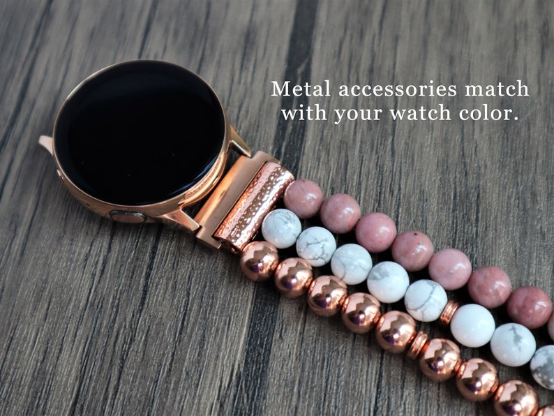 May include: A rose gold smartwatch band with a black watch face and a multi-strand beaded bracelet. The bracelet features pink, white, and rose gold beads. "Metal accessories match with your watch color." is written in the image.