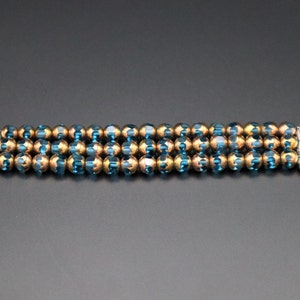 May include: A beaded watch band with alternating blue and gold beads. The band is designed to fit an Apple Watch.