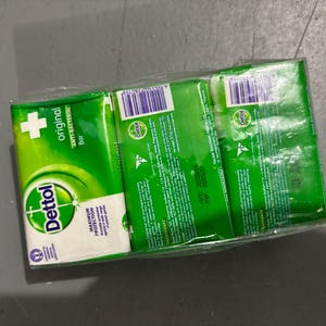 May include: A three-pack of Dettol Original Anti-Bacterial soap bars wrapped in clear plastic. Each green and white rectangular package features the Dettol logo, the text Original Anti-Bacterial Bar, and a net weight of 65g printed on the back.