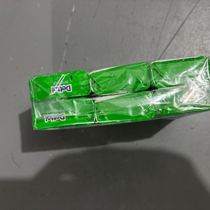 May include: A multi-pack of Dettol Original soap bars wrapped in clear plastic film. The packaging features a vibrant green color scheme with the white Dettol logo and the word original printed clearly on the front of each individual soap bar.