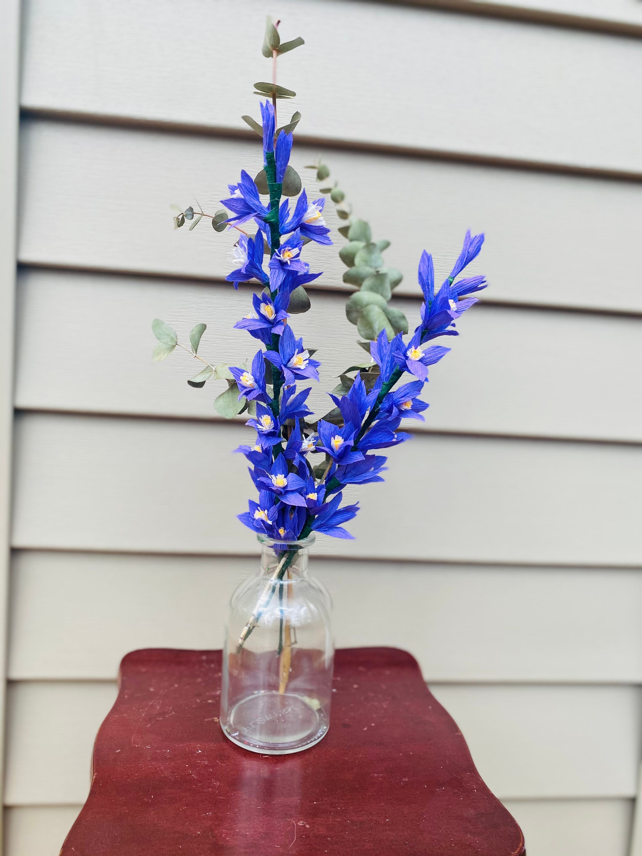 Image of A cluster of Delphinium flowers in a vase