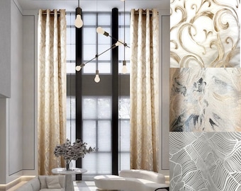 May include: A living room with large windows featuring gold patterned curtains. The room is decorated with a white couch and a small table with a vase of flowers. The windows have white blinds.