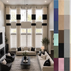 May include: Living room with tall, cream-colored curtains accented with black bands. The room features a fireplace, two sofas, and two armchairs. The windows have blinds, and the room is decorated in neutral tones.