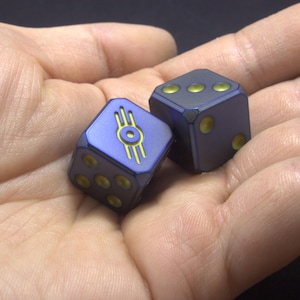 Titanium Vault-Tec Logo Dice &quot;Slightly Irradiated&quot; Finish., Inspired by the Fallout Series. Grade 5 Titanium. Logo on pip &quot;6&quot;.