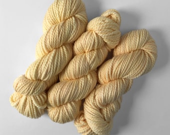Merino Yarn in Mango Cream tonal that is creamy white with a yellow tint, Hand-Dyed Bulky Weight 2-ply superwash wool