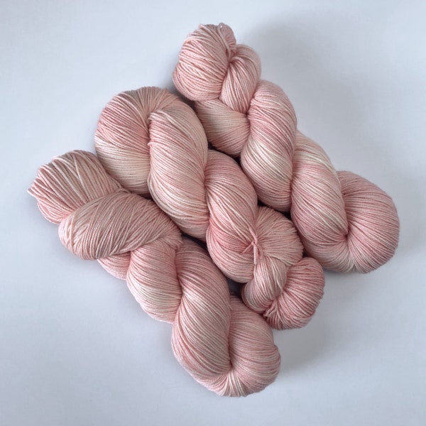 Pink Sock Yarn in “Cherry Blossom” - hand-dyed superwash merino in tonal pastel peach(ish) pink - quantity discounts - caking available