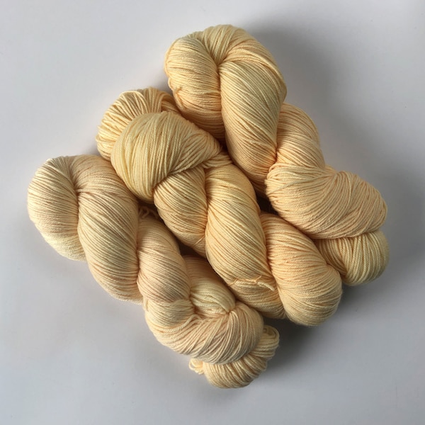 Hand-dyed sock yarn in "Mango Cream" (yellow peach) merino - free USA shipping - quantity discounts - caking service (see item description)