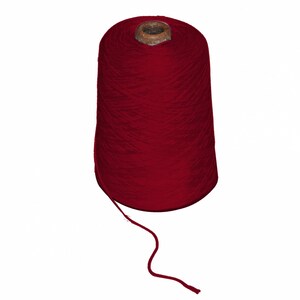 May include: A large cone of deep red yarn, ideal for knitting or crocheting projects. The yarn is tightly wound, with a single strand extending from the cone. The cone has a wooden core.