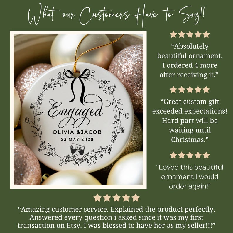 May include: A white ceramic ornament with the word "Engaged" in elegant script, surrounded by a floral wreath. The names Olivia & Jacob and the date May 25, 2026, are printed below. The ornament is hanging with a gold string, surrounded by other Christmas ornaments.