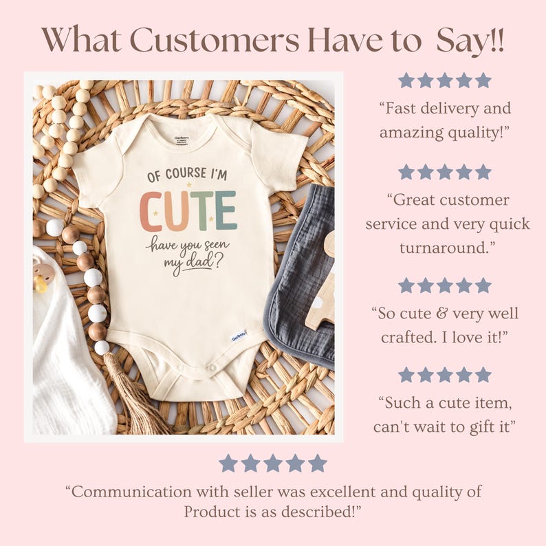 May include: Cream-colored baby onesie with the text "OF COURSE I'M CUTE have you seen my dad?" in colorful letters. The onesie is displayed on a woven basket with a gray burp cloth and wooden beads.