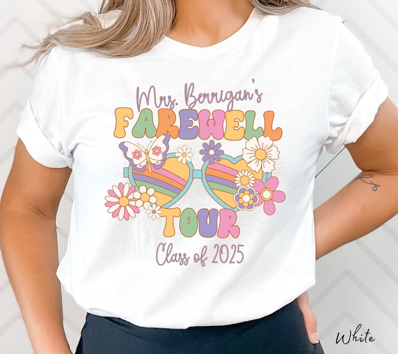 May include: White t-shirt with a retro-style graphic design featuring the text "Mrs. Berrigan's Farewell Tour Class of 2025" with colorful flowers and sunglasses.
