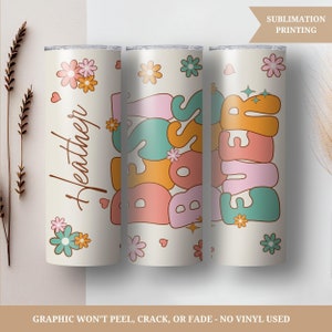 May include: Three stainless steel tumblers with a white background and colorful designs. The first tumbler has the name "Heather" written in cursive. The second tumbler has the word "Boss" written in large, colorful letters. The third tumbler has the word "Ever" written in large, colorful letters.
