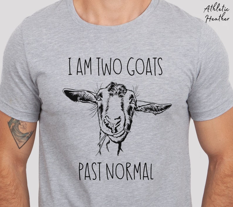 May include: A gray t-shirt with the text "I am two goats past normal" and a black and white illustration of a goat's head.