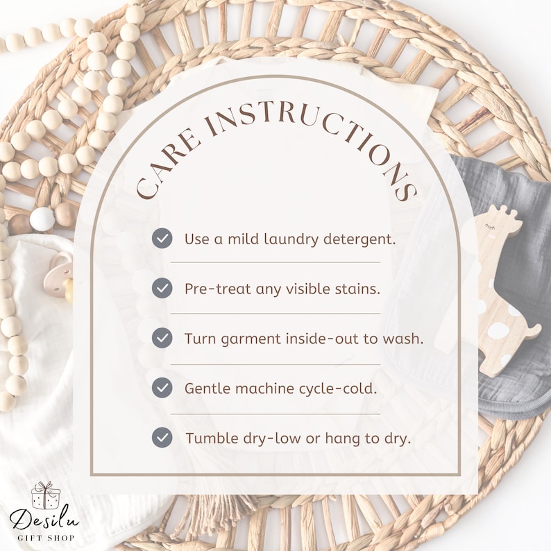 May include: A beige card with "CARE INSTRUCTIONS" and bullet points for washing instructions. The instructions include using mild detergent, pre-treating stains, washing inside-out, gentle cold cycle, and tumble dry low or hang to dry. A wooden giraffe toy is visible.