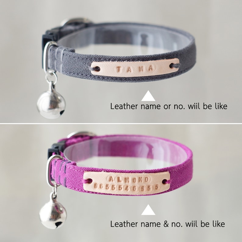 May include: Two cat collars with a bell charm. The first collar is gray with a leather name tag that says "TAMA". The second collar is purple with a leather name tag that says "ALMOND 0655546955".