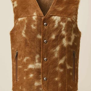 May include: Brown and white patterned vest with a V-neck and three button closure. The vest has two zippered pockets and is made of a textured material. The vest is a medium length.