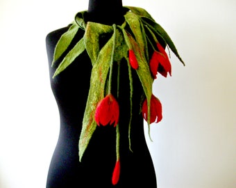 May include: A green felt necklace with red felt tulips. The necklace is draped over a black mannequin.