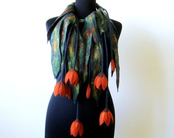 May include: A dark blue and green felted scarf with orange flower accents. The scarf is draped over a mannequin.
