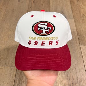 May include: A handmade, wooden serving tray with a natural finish. The tray features a rectangular shape with rounded corners and raised edges. It has two cut-out handles for easy carrying. The wood grain is visible, adding to its rustic charm.