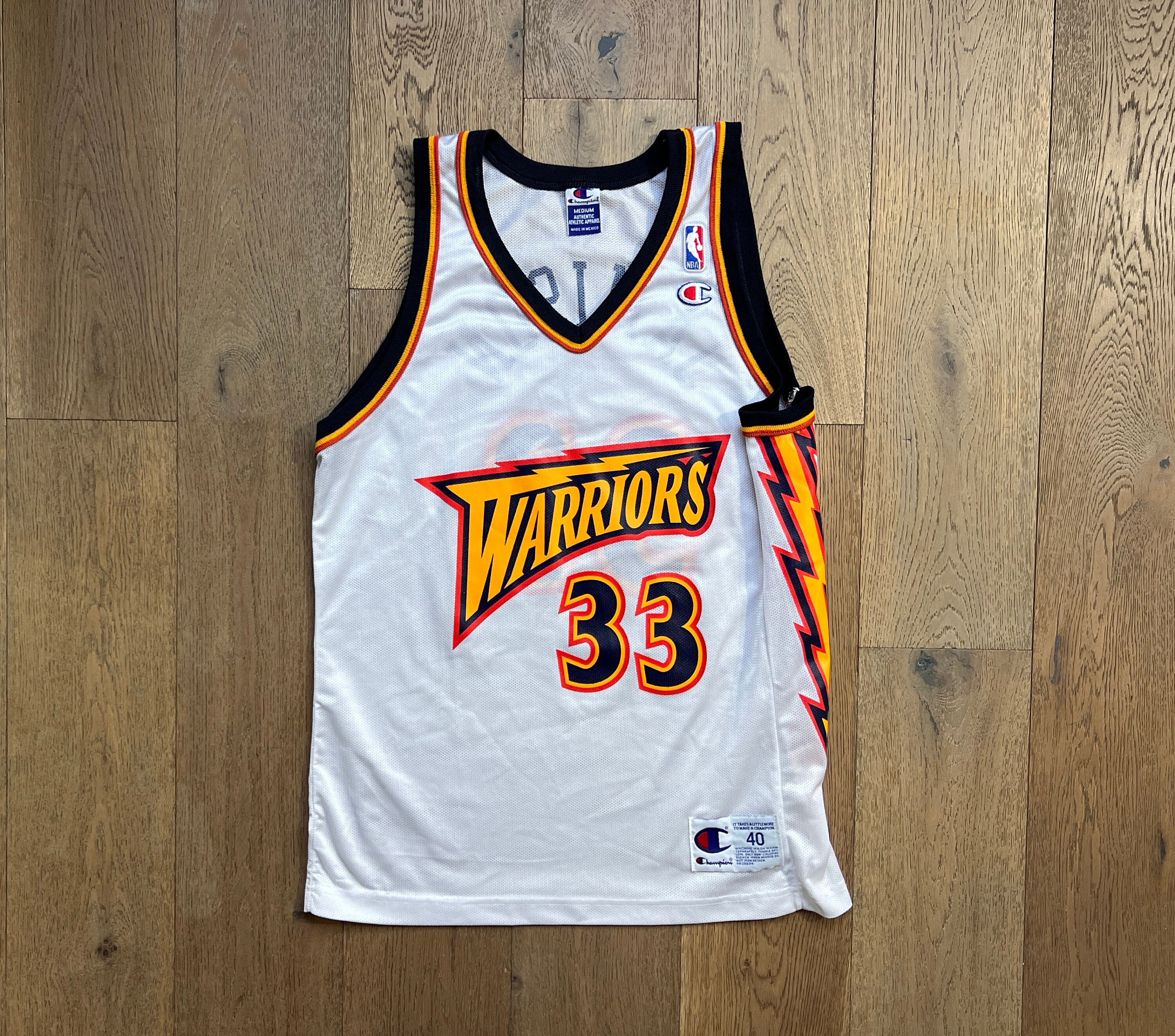 TWO CUSTOM POLYESTER SLEEVELESS SPORTS JERSEYS, CIRCA 1999