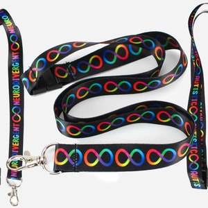 May include: Two black lanyards with rainbow infinity symbols and text. One lanyard says "Neurodivergent" and the other says "Autistic".