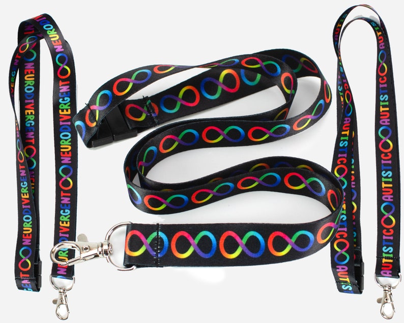 May include: Two black lanyards with rainbow infinity symbols and text. One lanyard says "Neurodivergent" and the other says "Autistic".