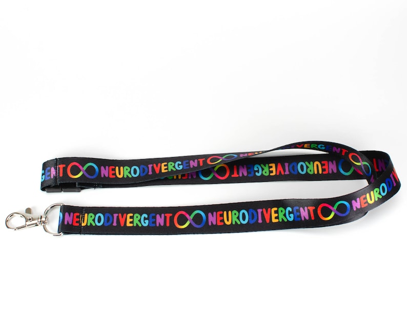 May include: Black lanyard with a repeating pattern of the text "Neurodivergent" and a rainbow infinity symbol.