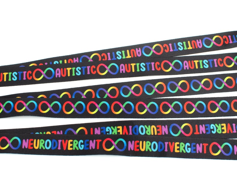 May include: Five black ribbon lanyards with rainbow infinity symbols and the text "AUTISTIC" and "NEURODIVERGENT" printed on them.