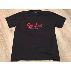 May include: Black t-shirt with a red "Polo Sport Ralph Lauren 1967" logo.