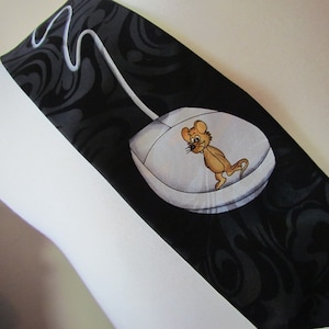 May include: A black silk tie with a white computer mouse and a cartoon mouse on it. The mouse has a brown body and a white tail.