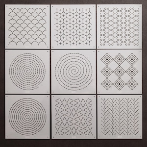 May include: Nine different stencil designs on white card stock. The designs include a spiral, a geometric pattern, a wave pattern, and more.