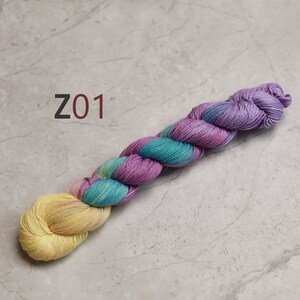 May include: A skein of yarn in shades of yellow, teal, and purple. The yarn is twisted into a rope shape and labelled "Z01". visible creative mending thread