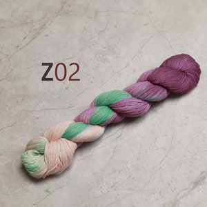 May include: A skein of yarn in shades of pink, green, and cream. The yarn is twisted into a rope shape and the label "Z02" is visible.