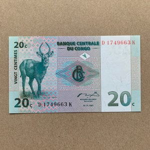 Demokratische Republik Kongo 20 Centimes Banknote. Kongolesische Währung. Wasserbock. Hinten, Wasserbockherde vor großem Baum. Papiergeld Erinnerungsstücke.