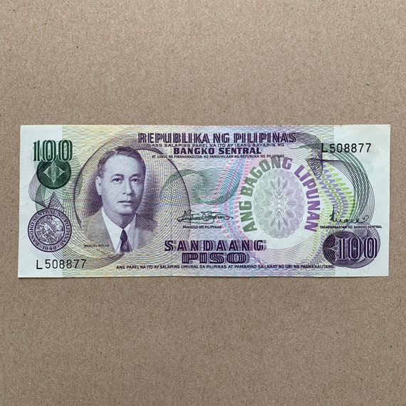 Philippines100 Piso pesos Aunc Banknote. Filipinocurrency. Manuel