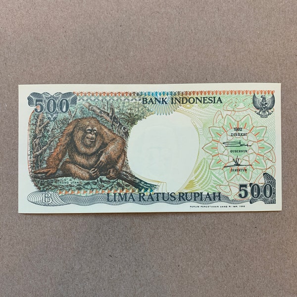 Orangutan Resting. 1992 Indonesian 5000 Rupiah Banknote. Indonesia Currency. Bills, Billetes, Note. Back: Native huts at E. Kalimantan