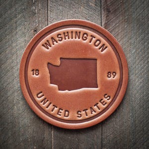 Posavasos de cuero con la silueta del estado de Washington