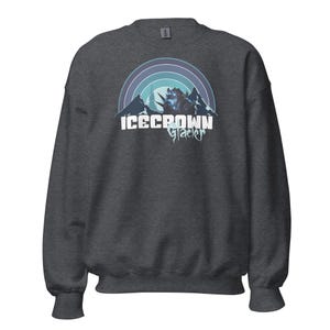 May include: A dark gray sweatshirt with a graphic of a mountain range with a blue and white color scheme. The text "Icecrown Glacier" is printed in white below the graphic.
