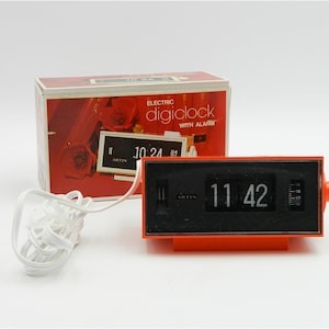 Orange vintage space age flip-number alarm clock by Artin, model 3700, from Hong Kong