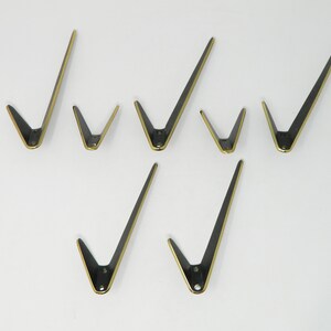 5 pieces big and 2 small brass coat hooks in V-form