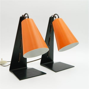Pair of J. T. Kalmar hook table lamps with orange shade and black base from the 50s
