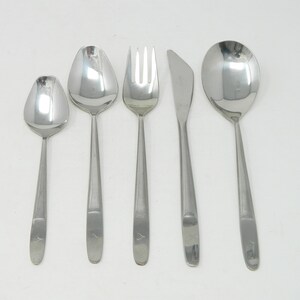 May include: A set of five silver-toned utensils, including a fork, knife, and three spoons.
