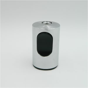 May include: A silver cigarette lighter with a black oval-shaped opening for lighter fluid.