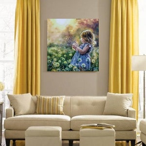 May include: A canvas print depicting a young girl in a blue dress blowing dandelion seeds in a field of flowers. The artwork is displayed on a neutral wall above a beige sofa, with yellow curtains on either side.